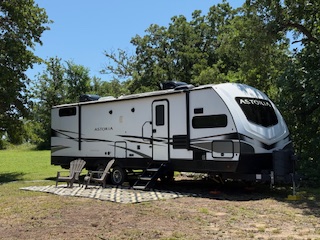2022 Dutchman Astoria 2913FK parked at campsite