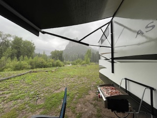 Cooking under the awning at a mountain campsite