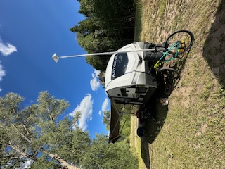 Our campsite setup with cell booster antenna and bicycle