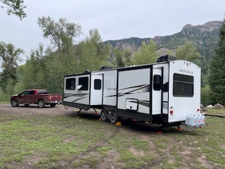 Our RV and truck at a mountain campsite